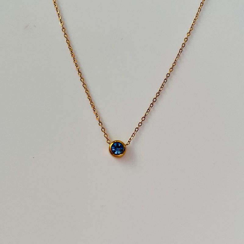 gold necklace with blue december birthstone