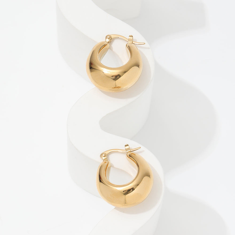 gold chunky hoop earrings on white stand