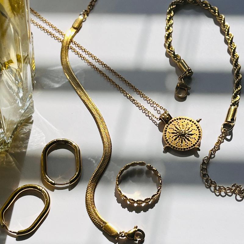 a collection of gold jewellery in sunlight