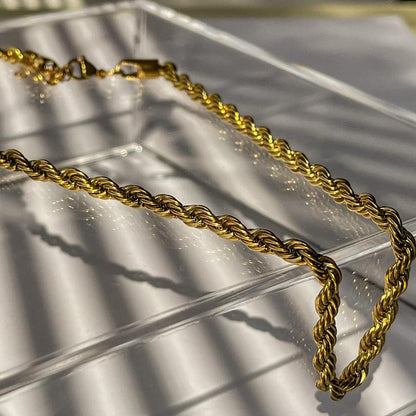 gold rope chain necklace on clear box